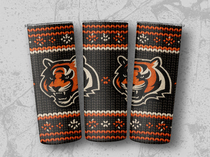 Three tumblers featuring a black knit pattern with orange and white tiger faces and snowflake designs.