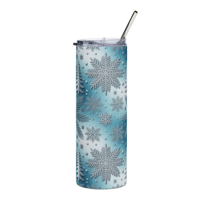 Tumbler with blue and white snowflake and pine tree pattern, and metal straw.
