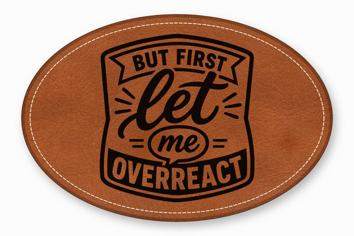 An oval brown leather patch with white stitched edges and black text reading But first let me overreact.