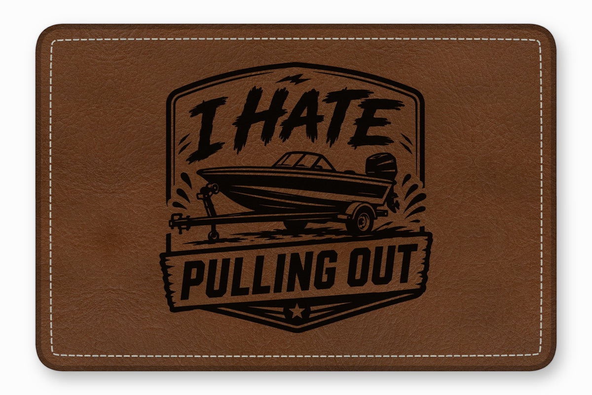 Brown leather patch with white stitching featuring an engraved boat graphic and the text I HATE PULLING OUT.