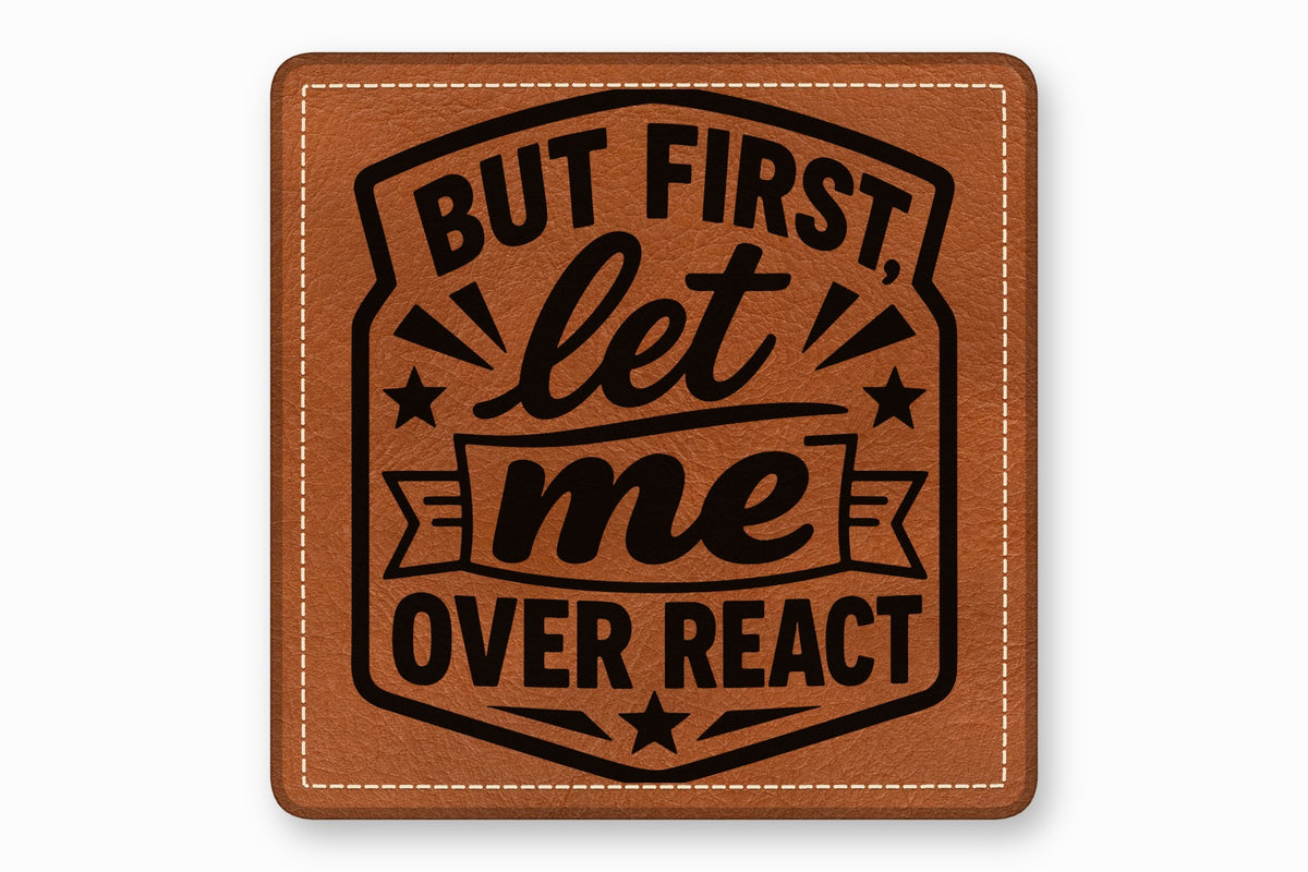 Brown leather patch with rounded corners, white border stitching, and black text that reads But First Let Me Overreact.
