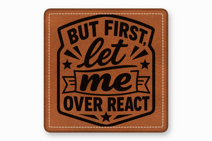 Brown leather patch with rounded corners, white border stitching, and black text that reads But First Let Me Overreact.