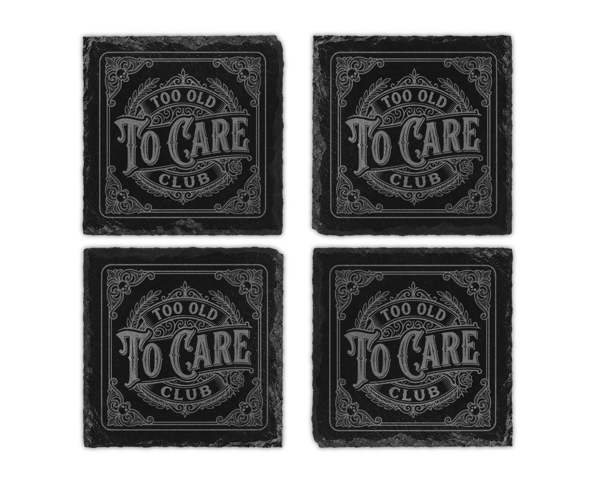 Four slate coasters, each engraved with "Too Old To Care Club".