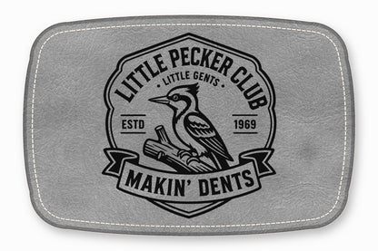 A gray leather patch with white stitched borders and a black woodpecker logo.