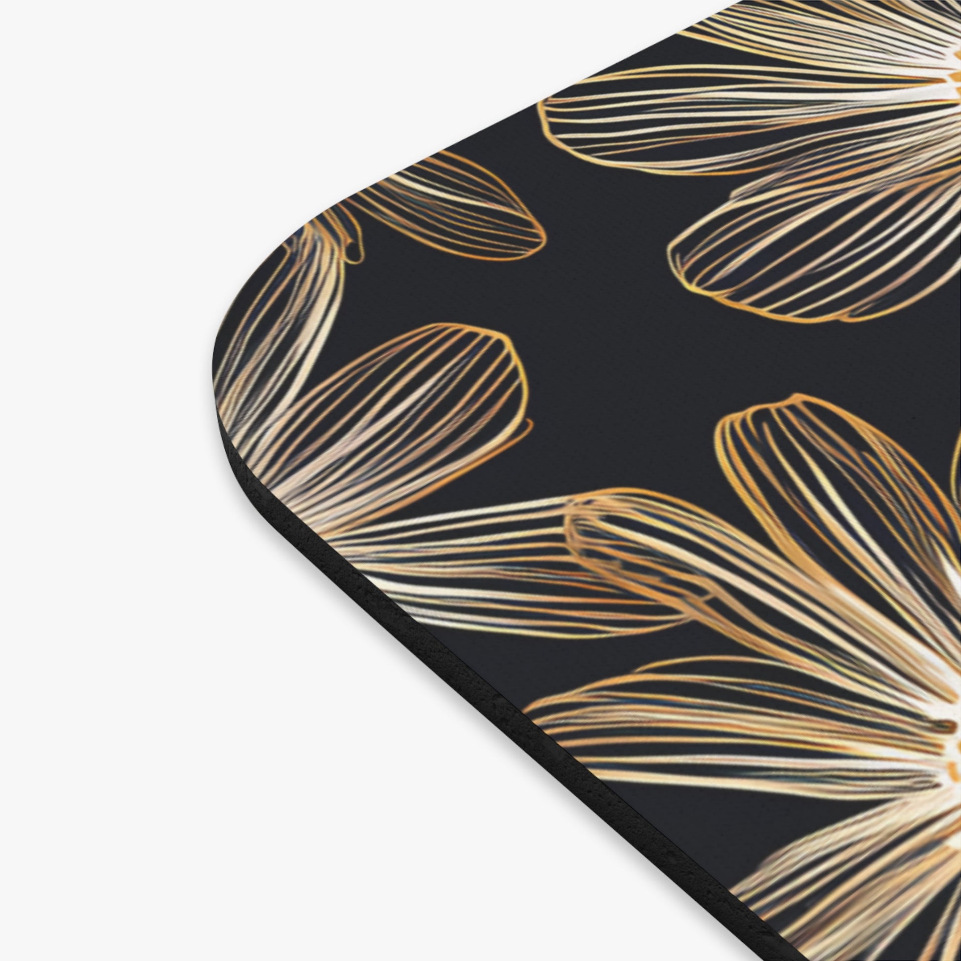 Black surface with a repeating gold line-art flower petal pattern.