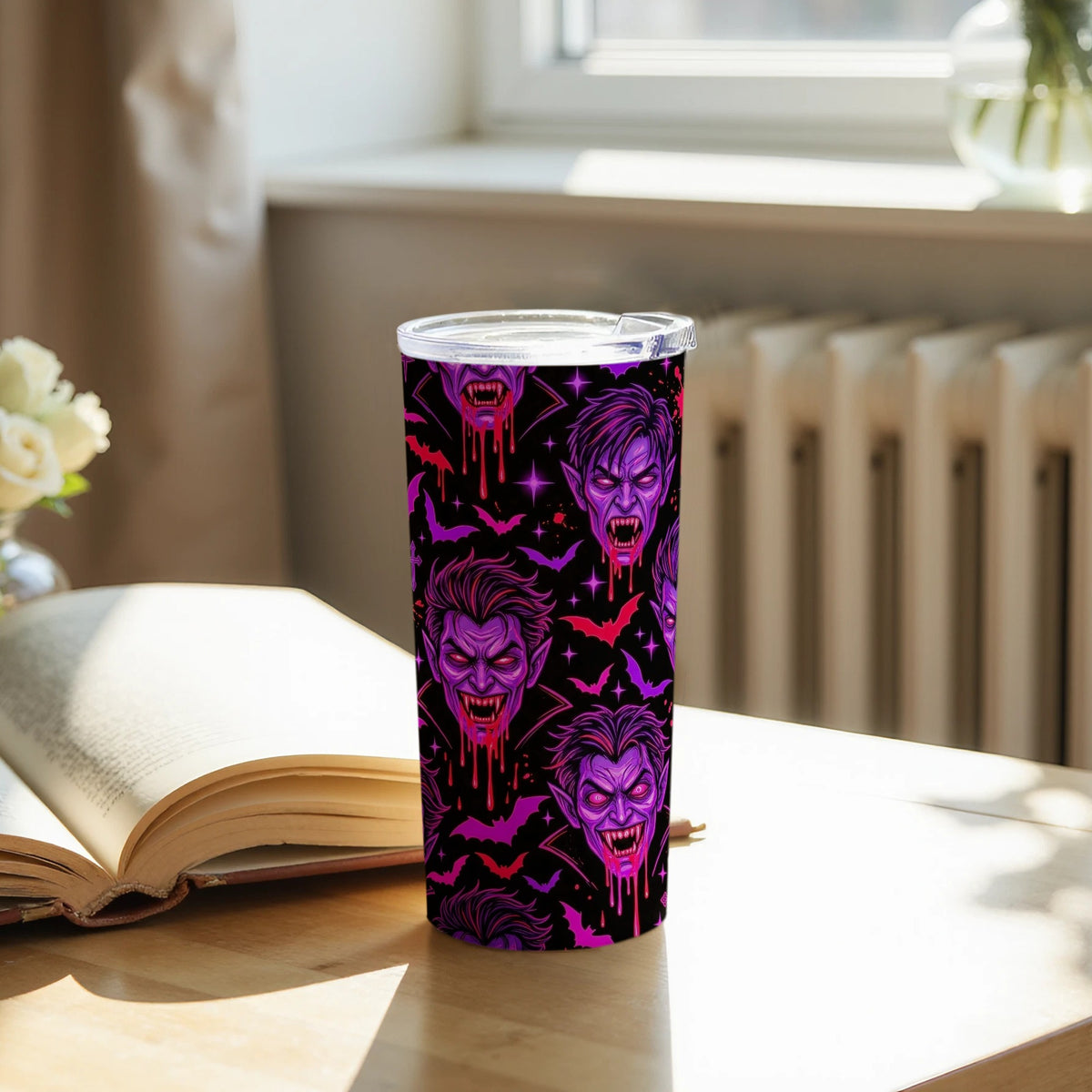Tumbler with purple vampire and bat pattern on black background.