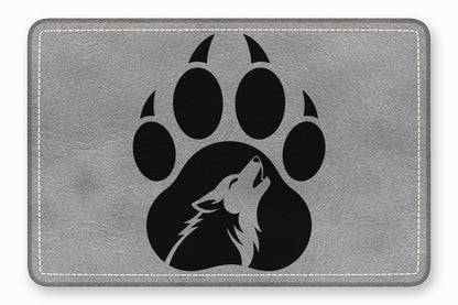 Gray leather patch featuring a black paw print with a howling wolf silhouette inside.