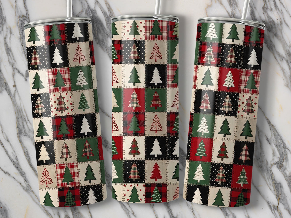 Three tumblers with a patchwork Christmas tree pattern on a marble background.