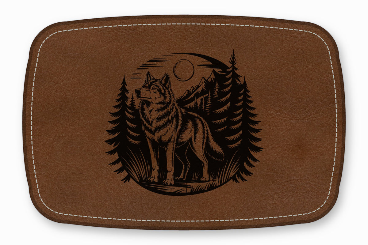 Brown leather patch with white stitched border featuring a laser-engraved wolf standing in a forest.