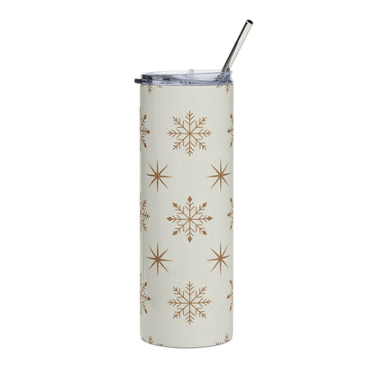 Tall tumbler with snowflake and star pattern and a metal straw.
