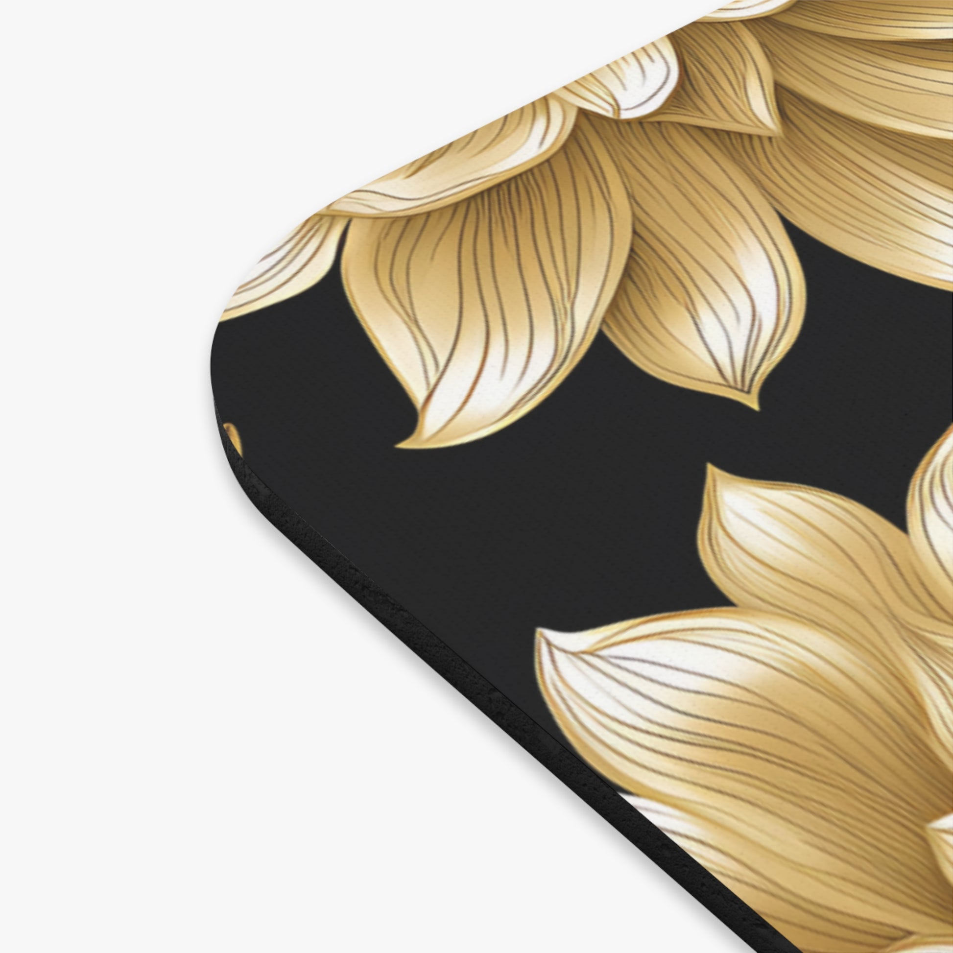Gold floral pattern on black mousepad with rounded corner.