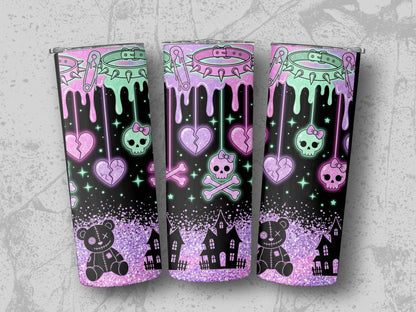 Tumblers with pastel goth drip design featuring skulls, broken hearts, teddy bears, and haunted houses.