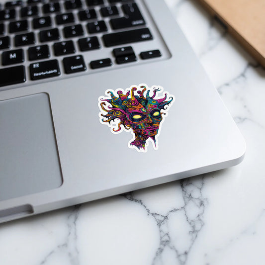 Colorful, abstract sticker of a creature's head with yellow eyes on a laptop.