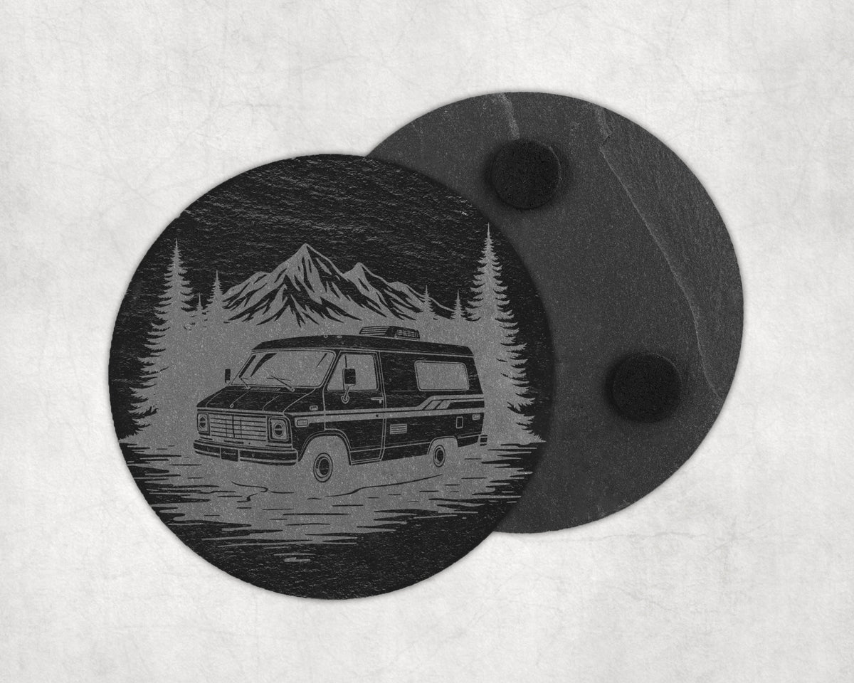 Slate coaster with engraved camper van, pine trees, and mountains scene.