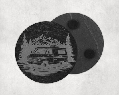 Slate coaster with engraved camper van, pine trees, and mountains scene.