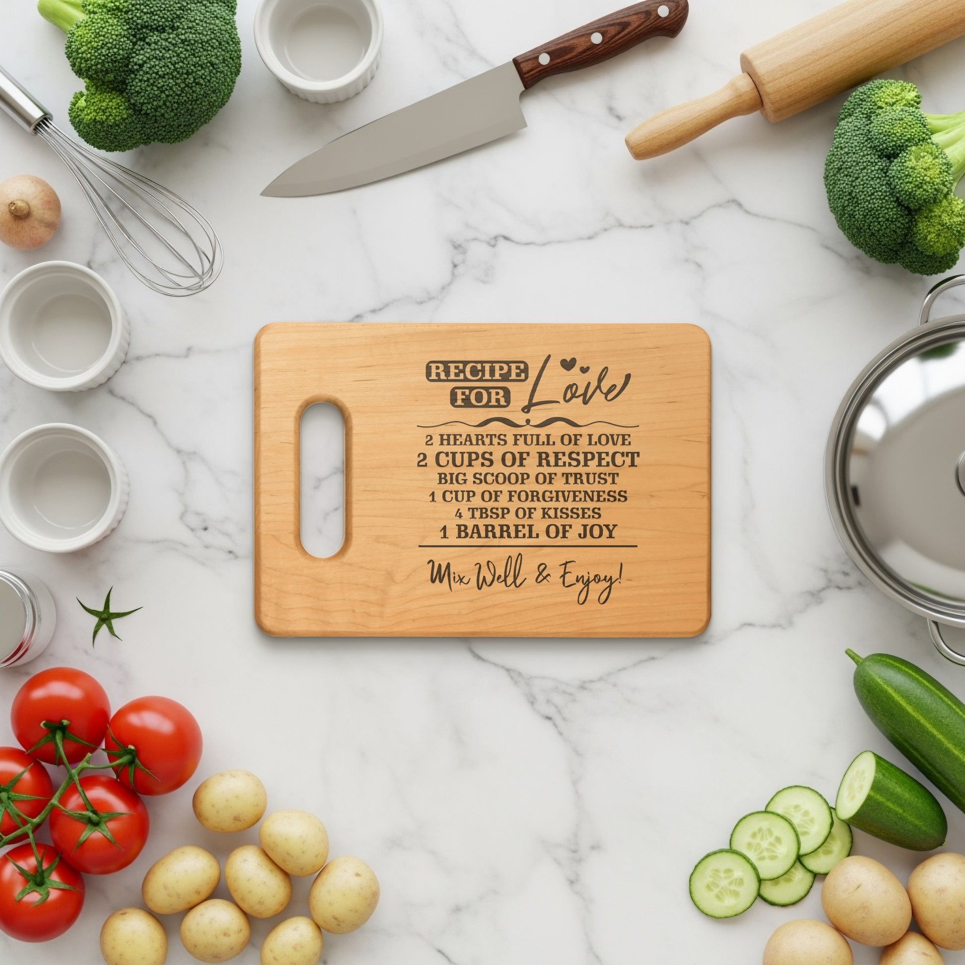 Wooden cutting board with "Recipe for Love" text and ingredients for cooking.