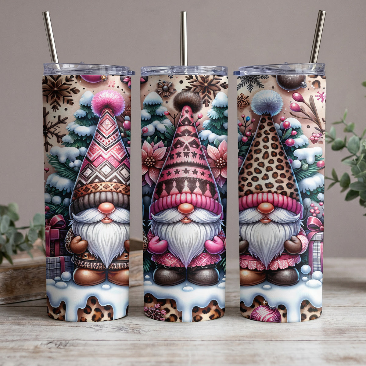 Three tumblers feature gnomes in patterned hats, pink outfits, and leopard print accents.