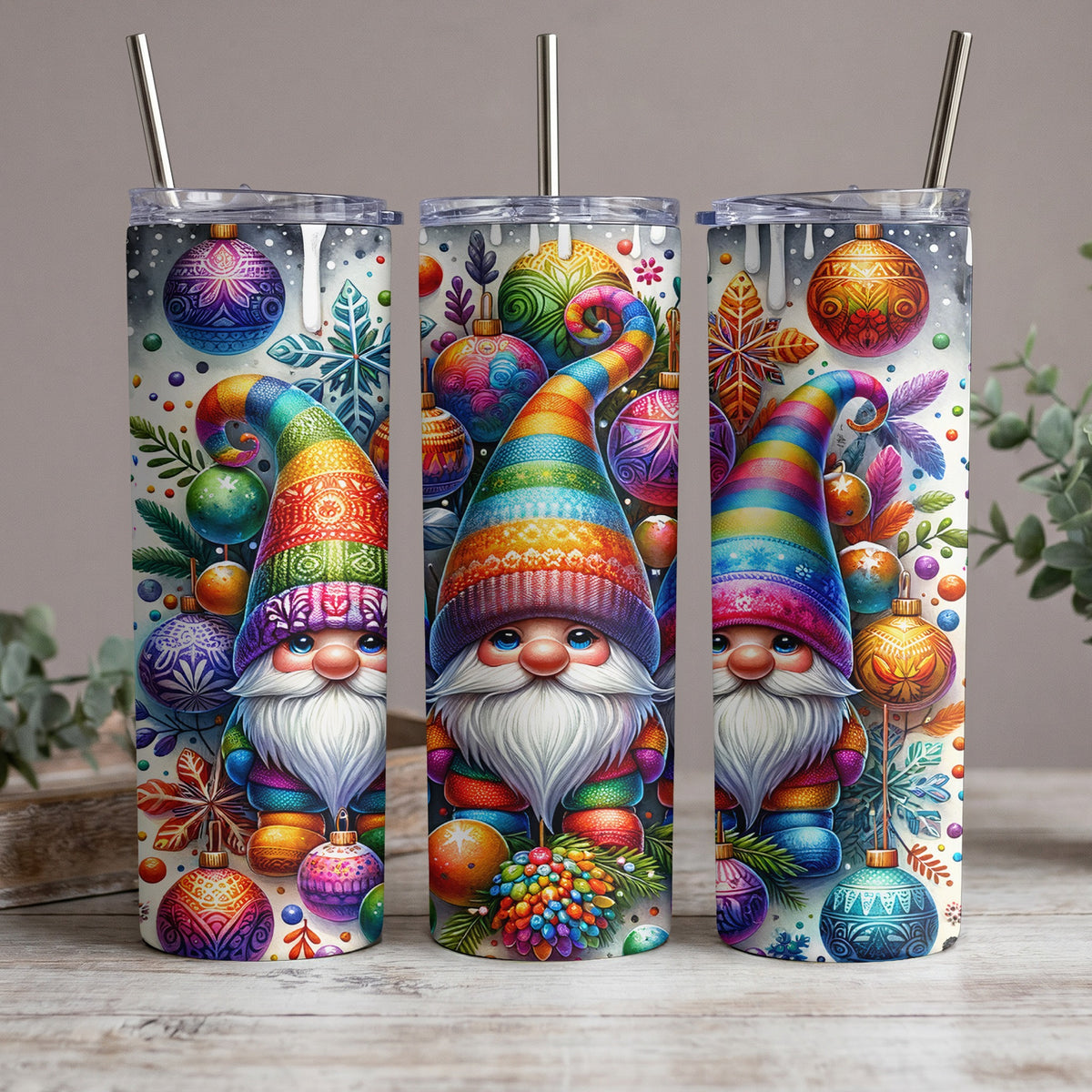 Three tumblers with colorful gnome and Christmas ornament designs.