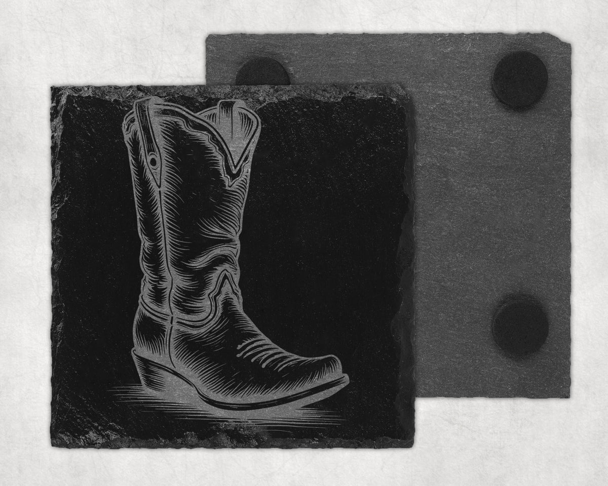 Engraved cowboy boot on a slate coaster, with another coaster behind.