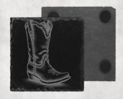 Engraved cowboy boot on a slate coaster, with another coaster behind.