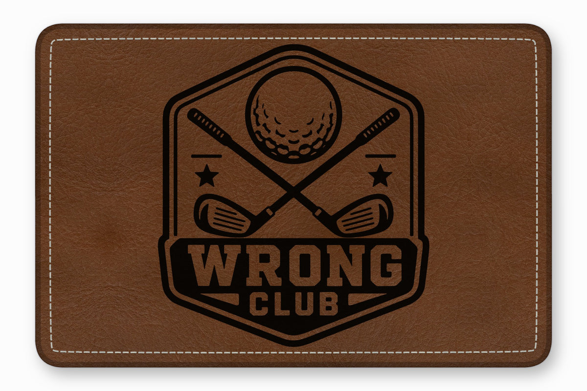 Brown leather patch with rounded corners, white stitching, and a black engraved golf emblem reading Wrong Club.