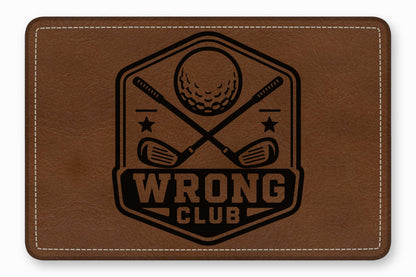 Brown leather patch with rounded corners, white stitching, and a black engraved golf emblem reading Wrong Club.