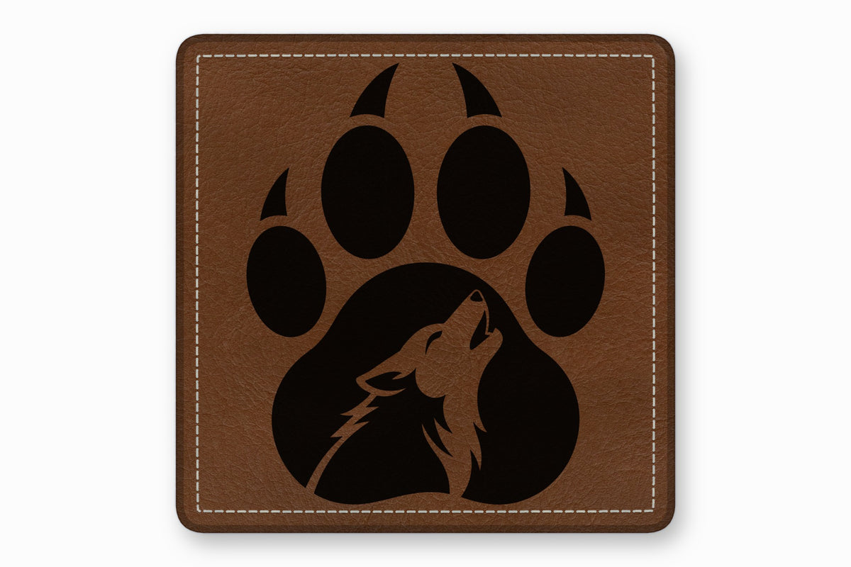 Brown leather square patch featuring a black bear paw print containing a howling wolf silhouette.
