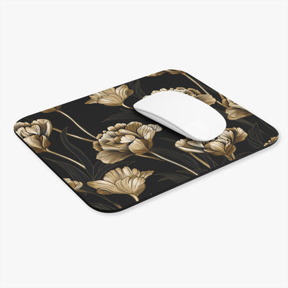 Black mousepad with gold floral pattern and a white computer mouse.