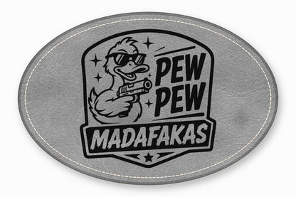 An oval gray leather patch featuring a duck wearing sunglasses and holding a gun, with text that reads PEW PEW MADAFAKAS.