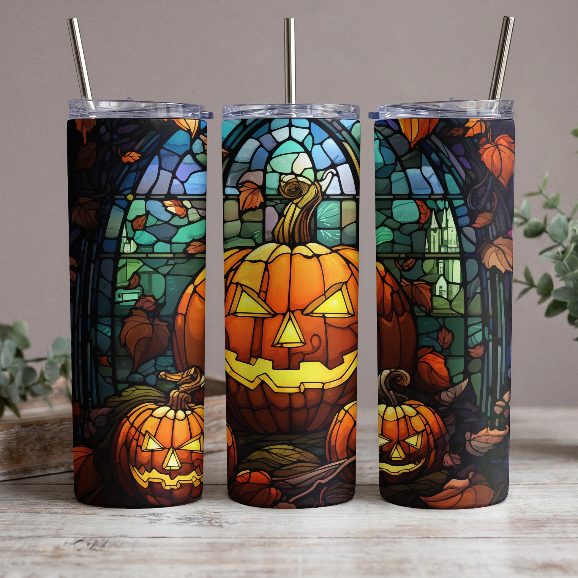 Three tumblers feature stained-glass style Halloween pumpkins and autumn leaves.