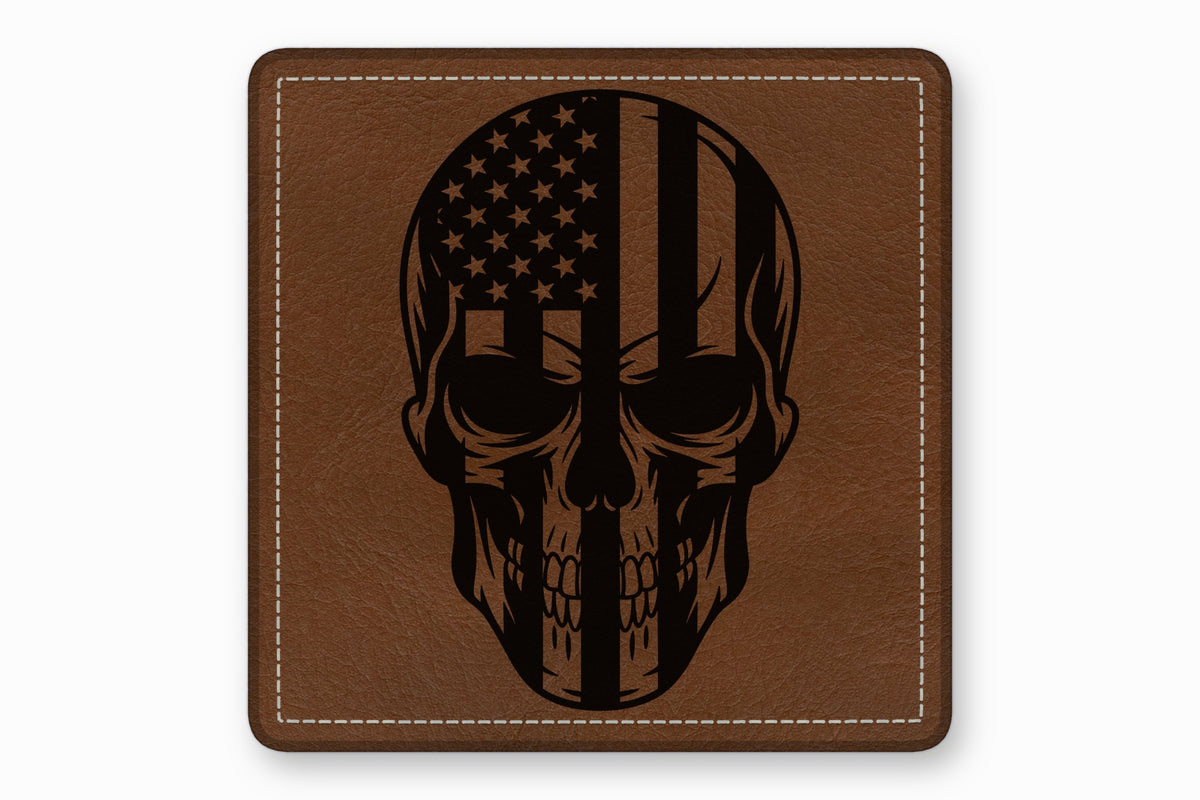 Square brown leather patch with white stitched border featuring a black skull and American flag graphic.