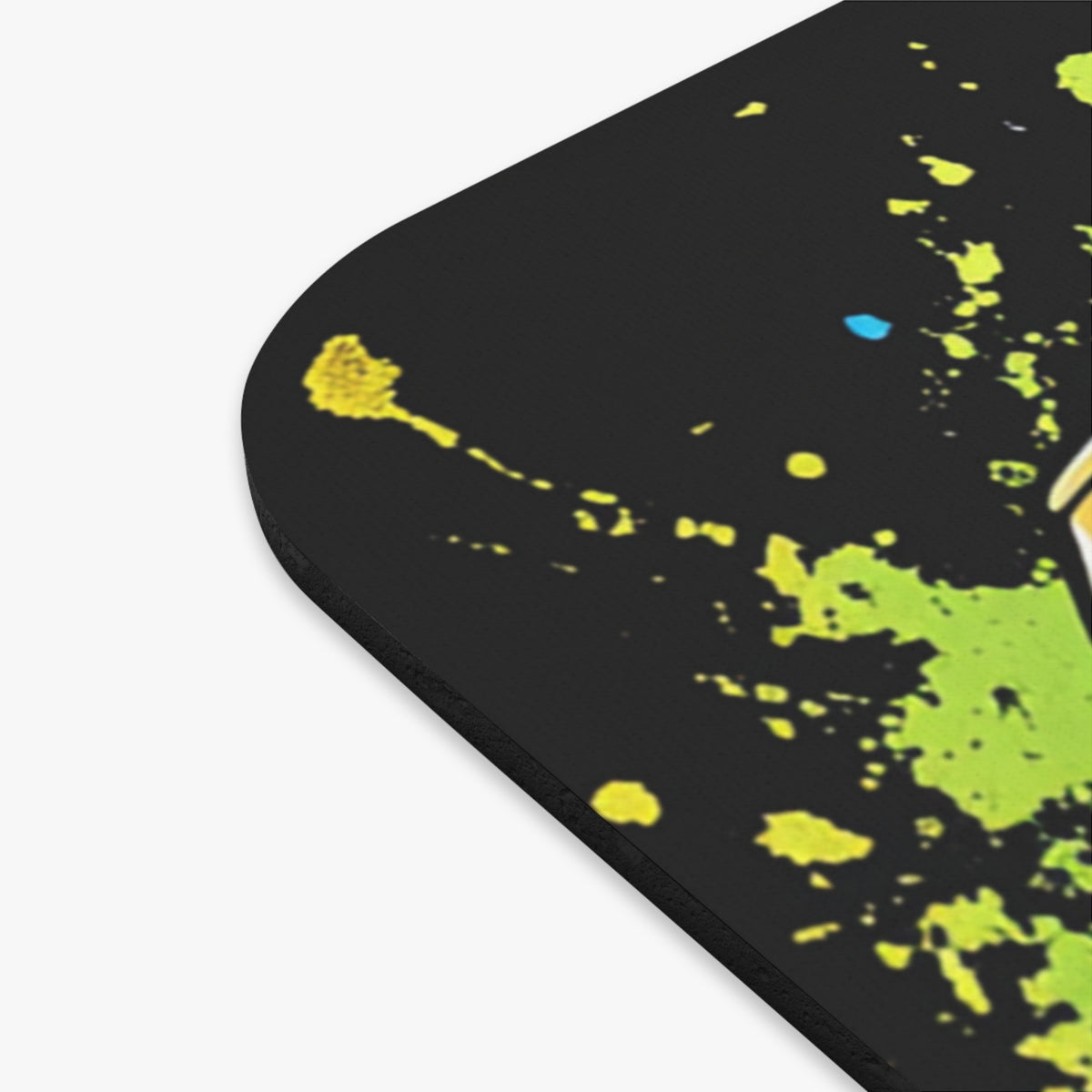 Black mousepad with yellow and green splatter paint design.