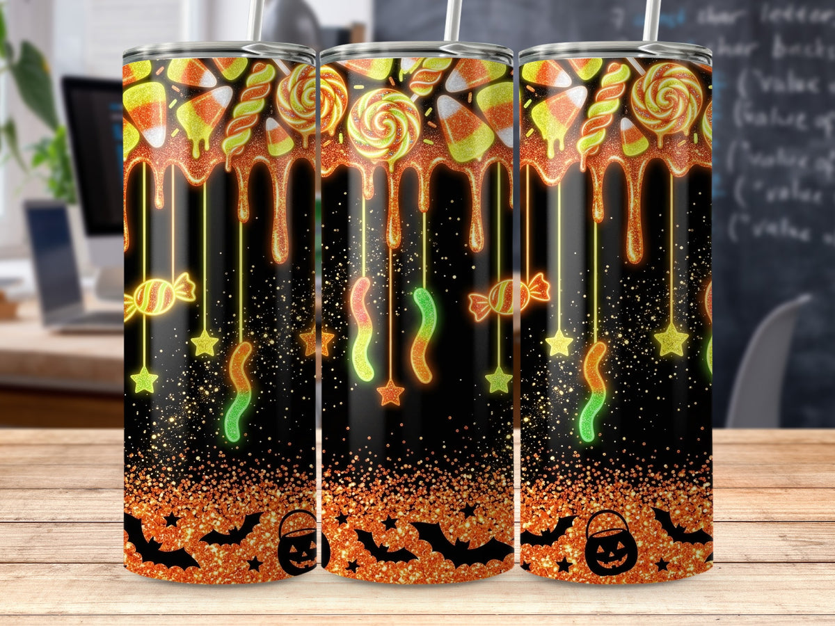 Tumbler with Halloween candy, dripping orange glaze, bats, and pumpkin bucket.