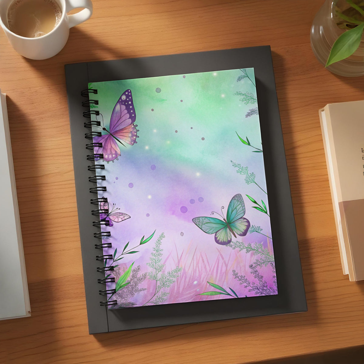 Spiral-bound notebook with purple and green watercolor butterfly design.