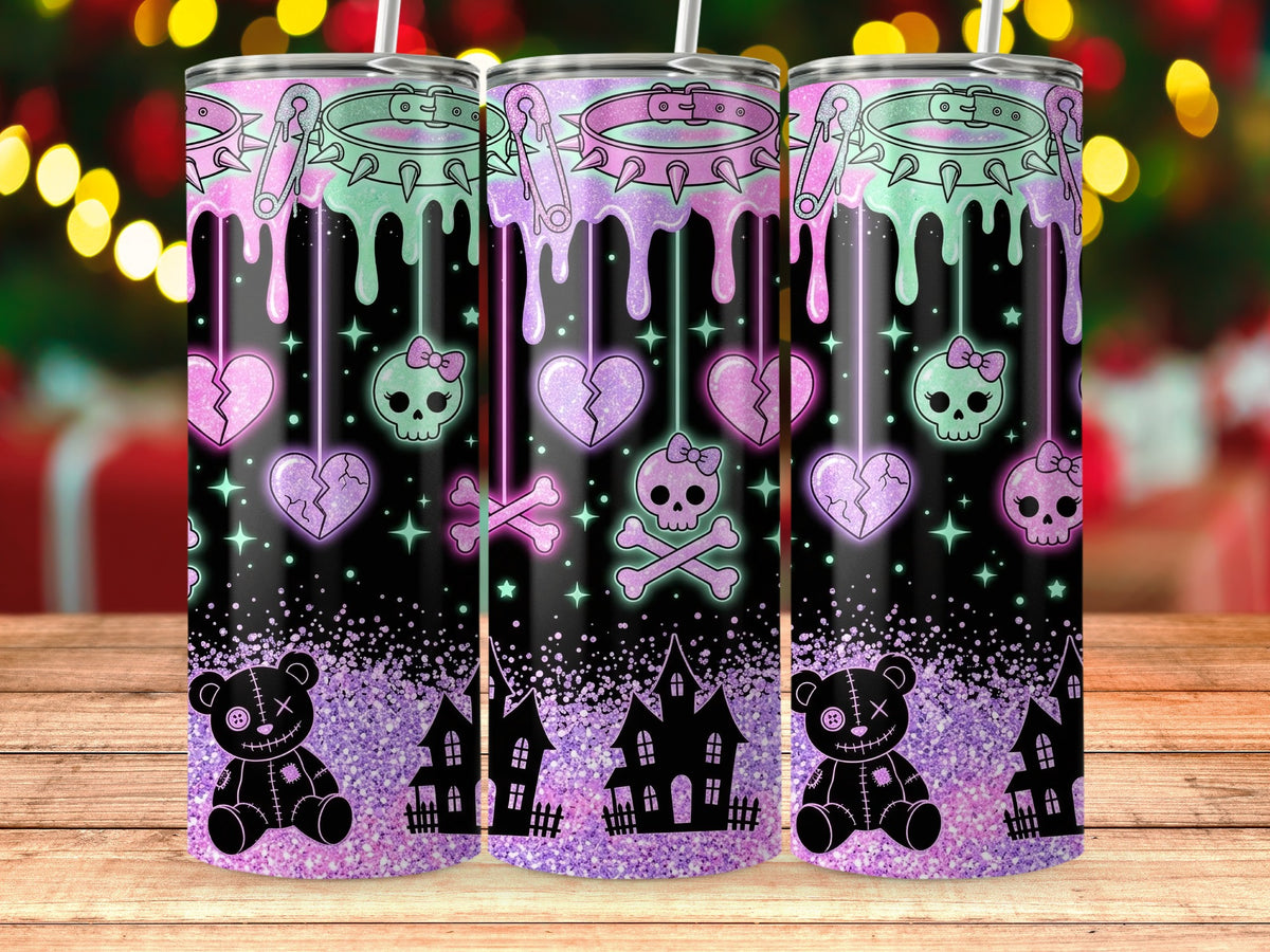 Three tumblers with spooky pastel gothic designs, including skulls, broken hearts, and teddy bears.