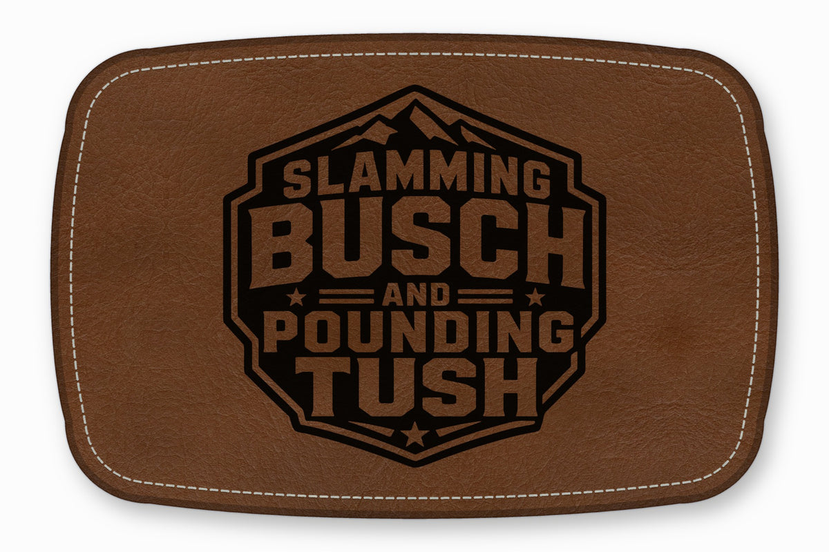 Brown leather patch with white stitching and a black stamped design reading Slamming Busch and Pounding Tush.