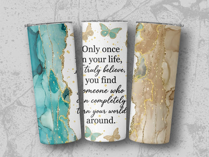 Three tumblers with marble and glitter designs and butterflies, one with quote.