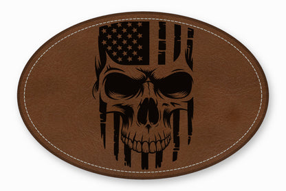 An oval brown leather patch featuring a black laser-engraved skull with an American flag pattern.