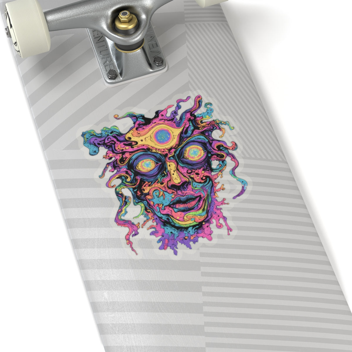 Psychedelic face sticker with trippy eyes on a skateboard deck.