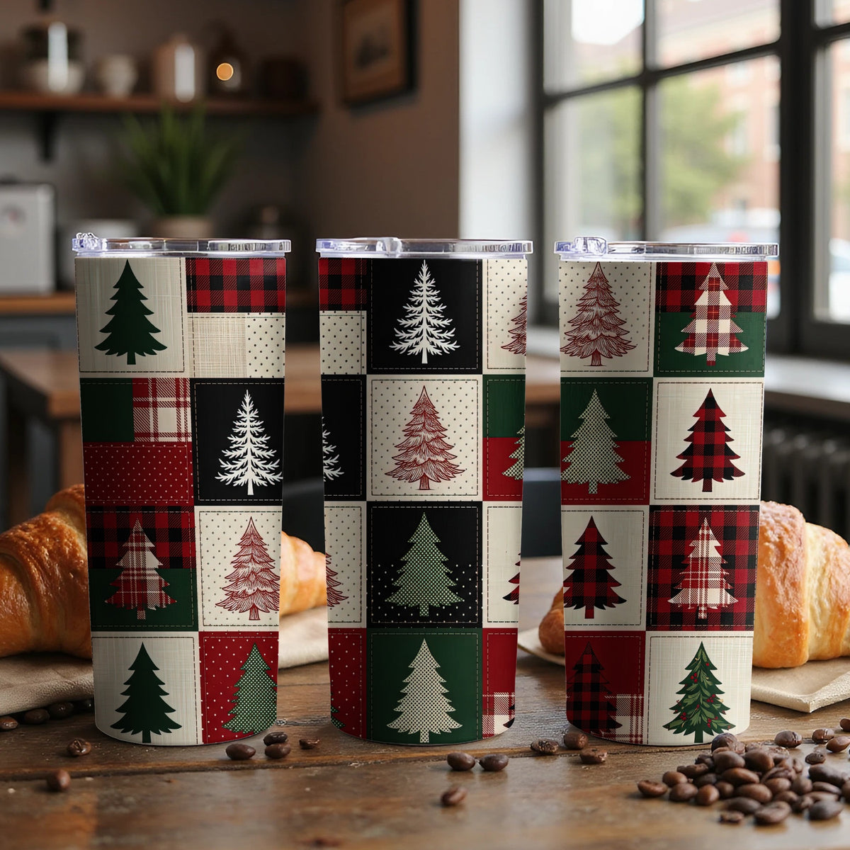 Three tumblers with a Christmas tree patchwork design on a wooden table.