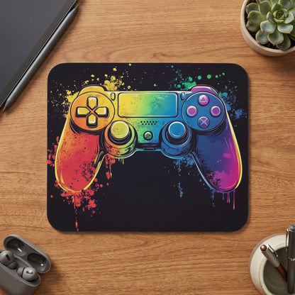 Gaming controller with rainbow watercolor splatter design on a black surface.