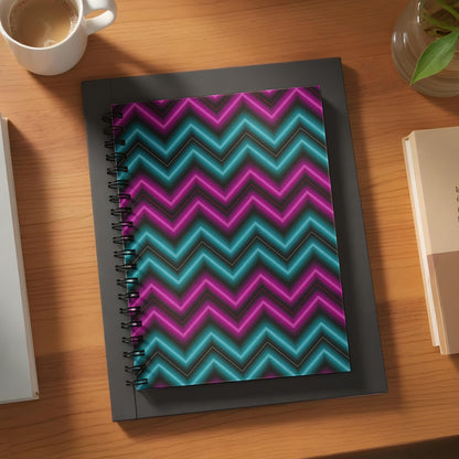 Spiral notebook with neon pink and blue chevron pattern on black background.