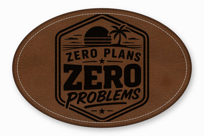 Oval brown leather patch with white stitched border, featuring a stamped palm tree sunset and the text ZERO PLANS ZERO PROBLEMS.