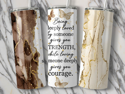 Three tumblers with marble and gold glitter designs, one with inspirational text and butterflies.