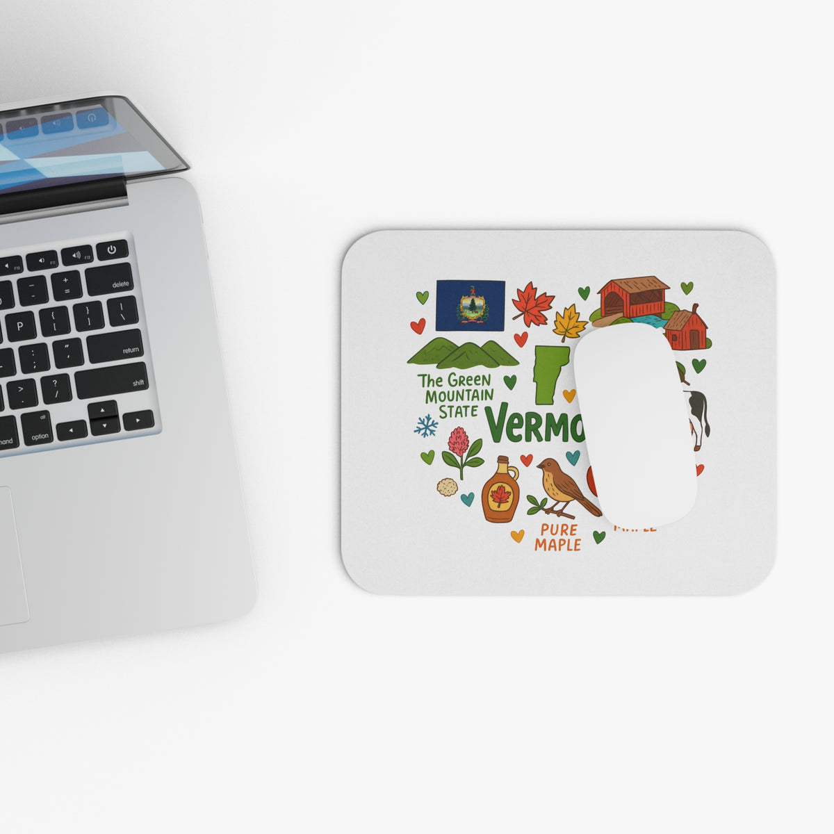 Mousepad with Vermont-themed illustrations, including the state flag, covered bridge, and maple syrup.