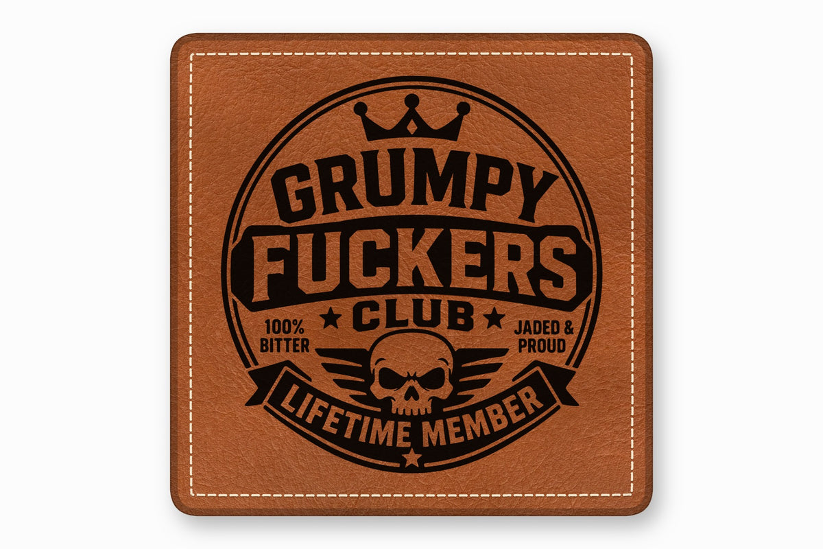 Square brown leather patch with white stitched border, featuring a black circular emblem reading Grumpy Fuckers Club Lifetime Member.