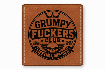 Square brown leather patch with white stitched border, featuring a black circular emblem reading Grumpy Fuckers Club Lifetime Member.