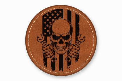 Round brown leather patch laser-engraved with an American flag, a skull, and two wrenches.