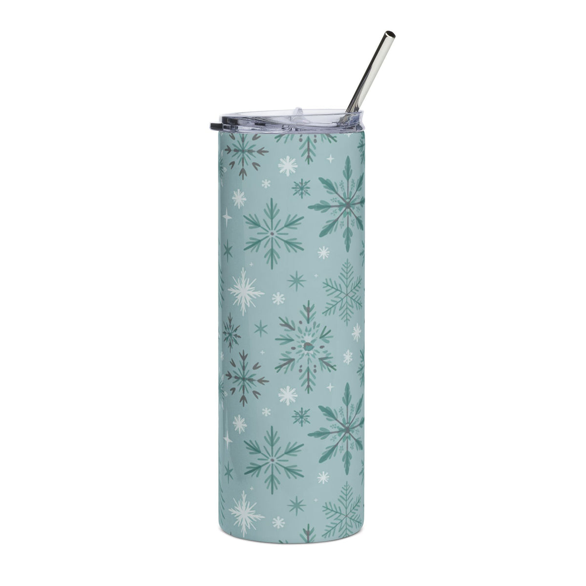 Tumbler with a blue background and a pattern of various green and white snowflakes, with a metal straw.