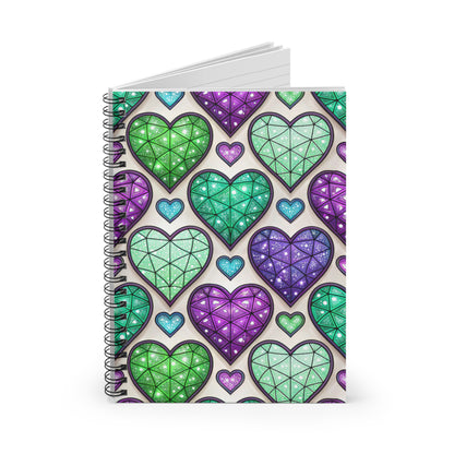 Spiral-bound notebook with a repeating pattern of glittery green and purple heart shapes.